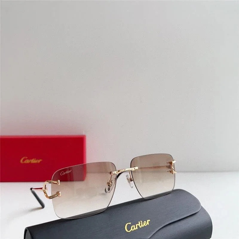 Gold-rimmed square sunglasses with brown gradient lenses displayed on a black case