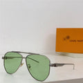 Aviator sunglasses with green tinted lenses and silver metal frame on white surface