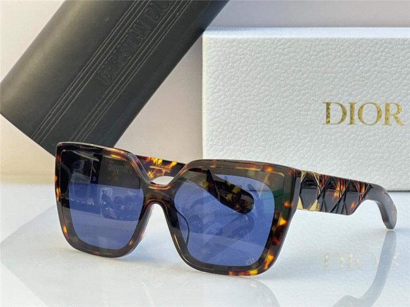 Tortoiseshell square sunglasses with blue lenses, patterned arms, luxury box background