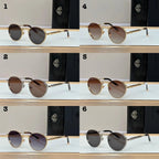 Six pairs of round sunglasses with metal frames and tinted lenses, displayed on a table.