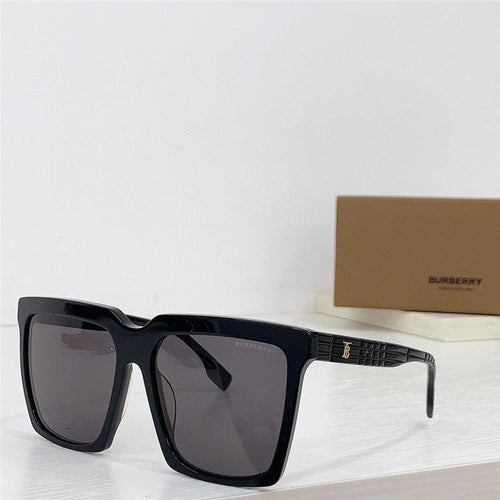 Black oversized square sunglasses with dark lenses on a white surface, designer case in background