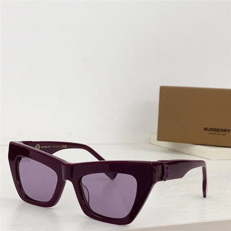 Purple cat-eye sunglasses with thick frames and tinted lenses on a white surface