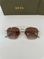Gold frame aviator sunglasses with brown gradient lenses on white surface, DITA case background