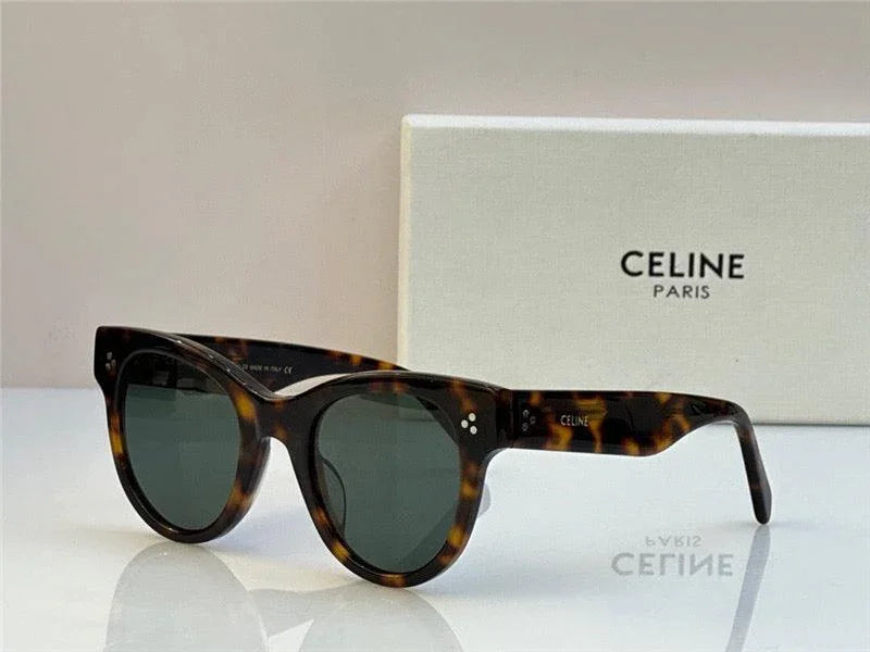 Tortoiseshell cat-eye sunglasses with dark lenses, CELINE Paris box in background.