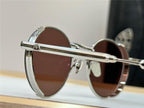 Close-up of round sunglasses with silver metal details and dark tinted lenses on display.