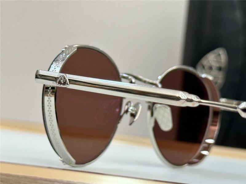 Close-up of round sunglasses with silver metal details and dark tinted lenses on display.