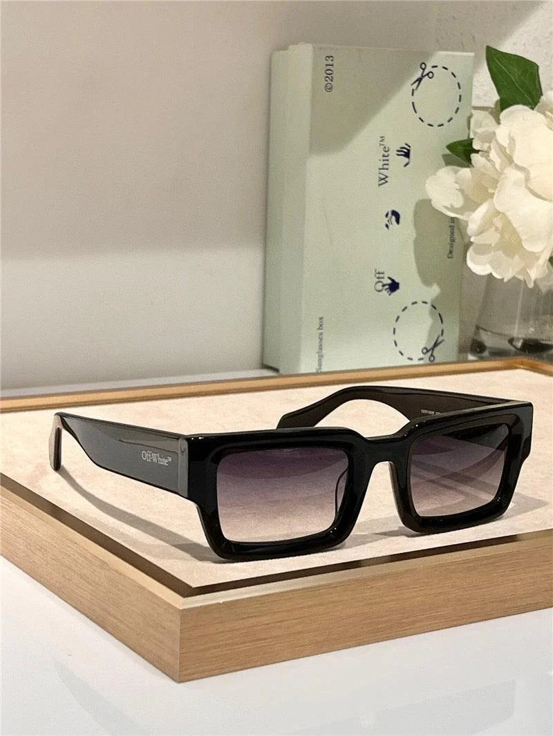 Black rectangular sunglasses with gradient lenses on display, modern stylish eyewear