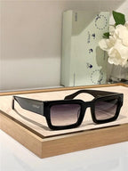 Black rectangular sunglasses with gradient lenses on display, modern stylish eyewear