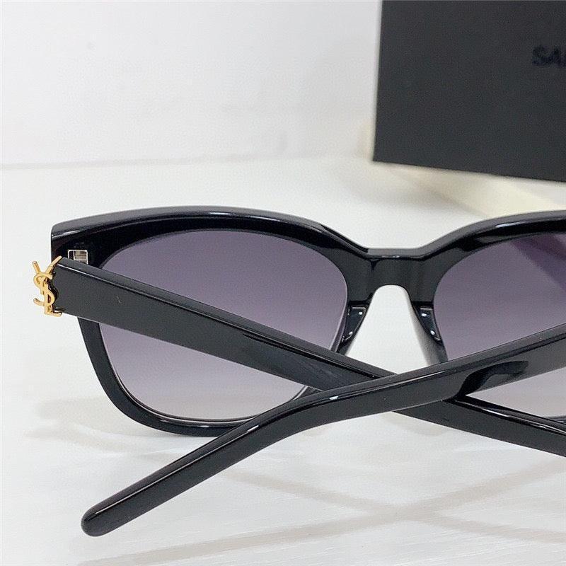 Black cat-eye sunglasses with gradient lenses and gold accent on temple, stylish eyewear