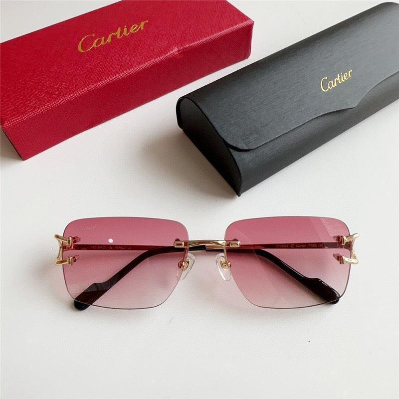 Rimless square sunglasses with pink gradient lenses, gold arms, next to branded cases.