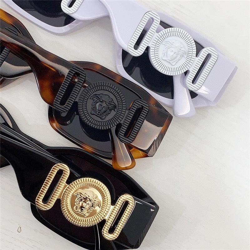 Luxury sunglasses with Medusa emblems in black, tortoise, and white stylish frames