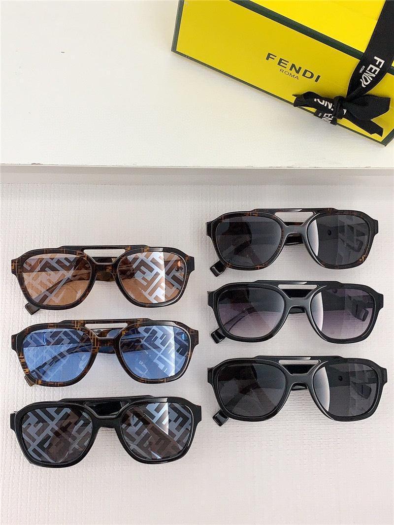 Six pairs of stylish sunglasses with patterned and tinted lenses, displayed beside a yellow Fendi box.