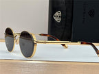 Luxury round sunglasses with gold metal frame, dark lenses, and tortoiseshell arms on display