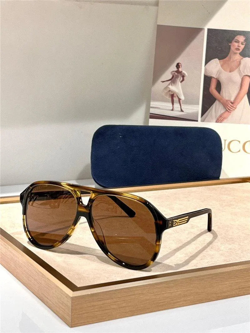 Tortoiseshell frame aviator sunglasses with brown polarized lenses on display tray