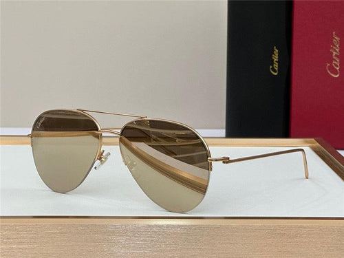 Gold aviator sunglasses with brown tinted lenses on display tray, luxury packaging in background.