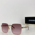 Square oversized sunglasses with purple gradient lenses and gold metal frame on a white surface