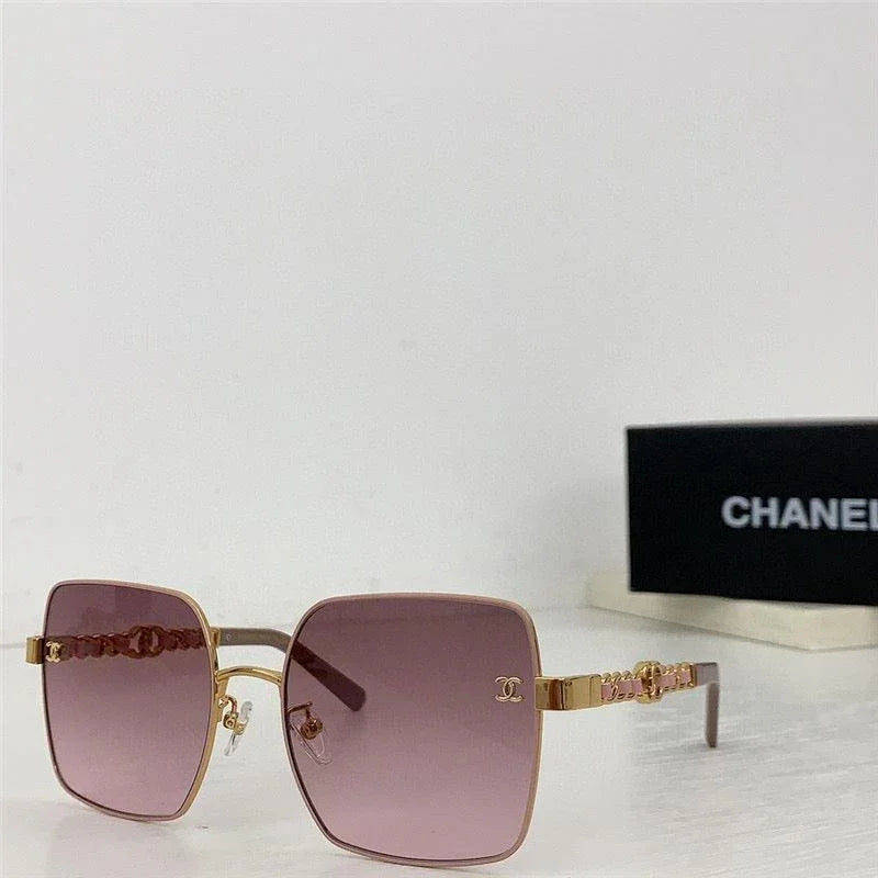 Square oversized sunglasses with purple gradient lenses and gold metal frame on a white surface