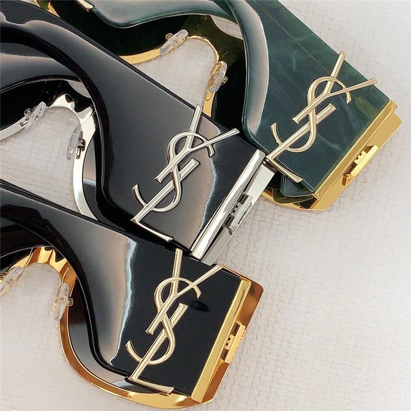 Close-up of luxury designer sunglasses with gold accents and bold frames