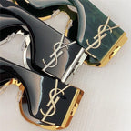 Close-up of luxury designer sunglasses with gold accents and bold frames