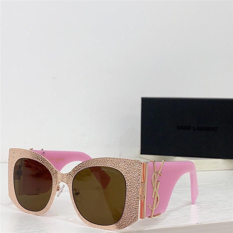 Pink oversized square sunglasses with textured gold frame and brown lenses on display
