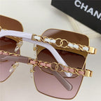 Square oversized sunglasses with gold chain arms, tinted lenses, and white or pink accents