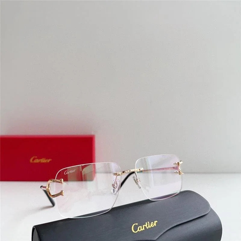 Rimless rectangular eyeglasses with gold accents and a black Cartier case on white background