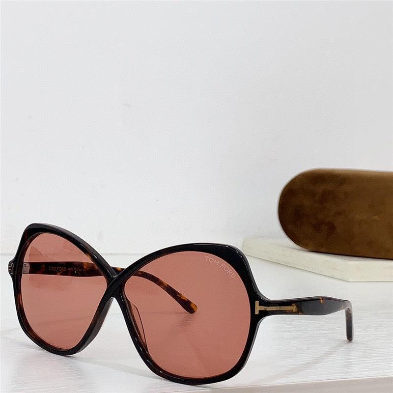 Oversized cat eye sunglasses with tortoiseshell frame and pink lenses, eyewear case in background