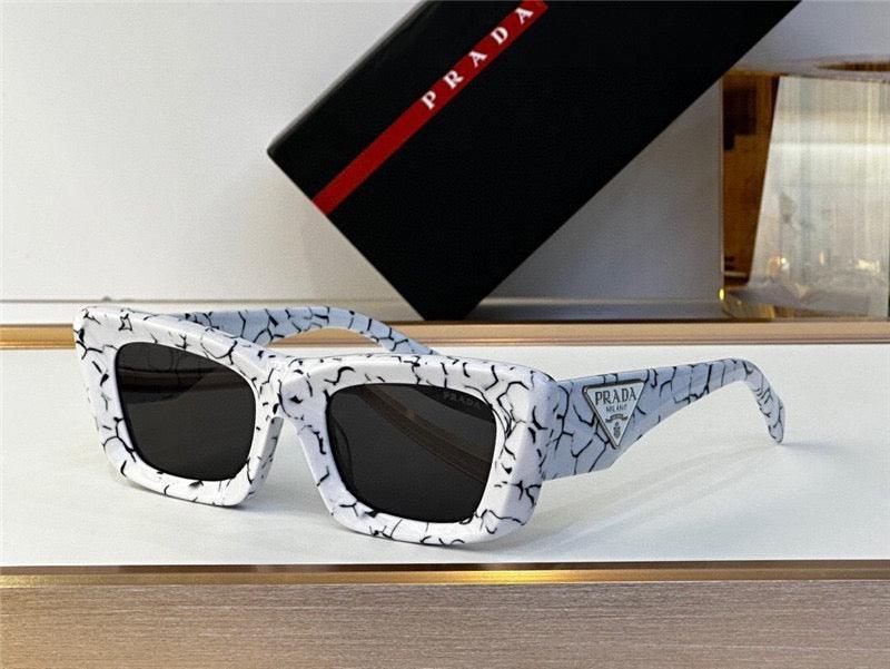 Chunky square white marble sunglasses with black lenses and bold patterned frames