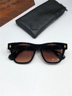 Black square sunglasses with brown gradient lenses and gold accents, displayed with a black leather case.