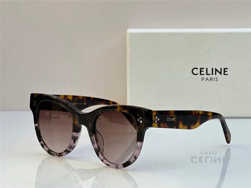 Tortoise shell cat-eye sunglasses with gradient lenses and Celine Paris case in background.