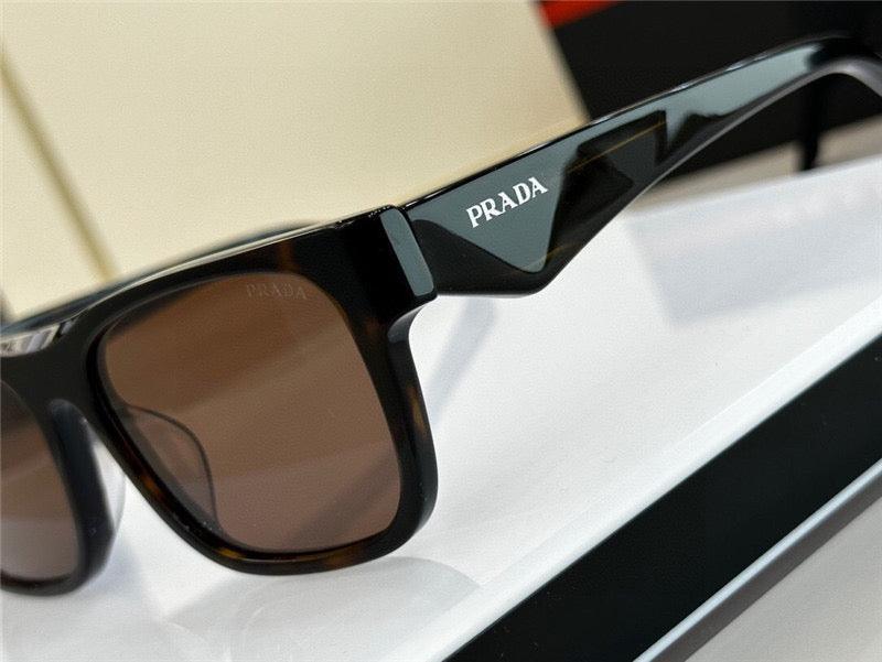 Black Prada sunglasses with brown lenses and bold frame, close-up product image.