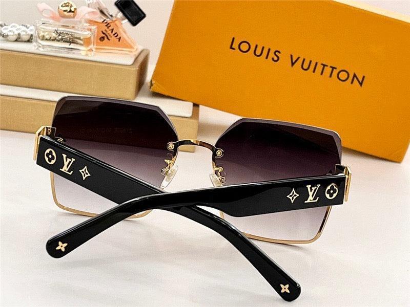 Designer black square sunglasses with gold accents and gradient lenses on display table