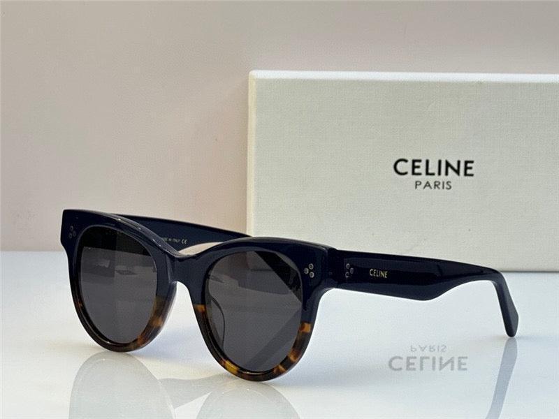 Dark round sunglasses with tortoiseshell accents and thick frames, set in front of a Celine Paris box