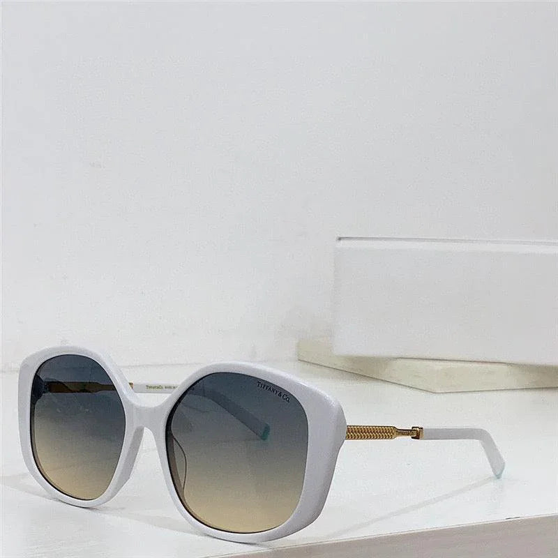 Square white frame sunglasses with gradient lenses and gold temples on a white surface