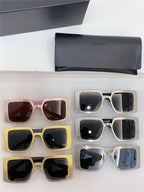 Six pairs of oversized square sunglasses with glitter frames in gold and silver, next to black Saint Laurent cases.
