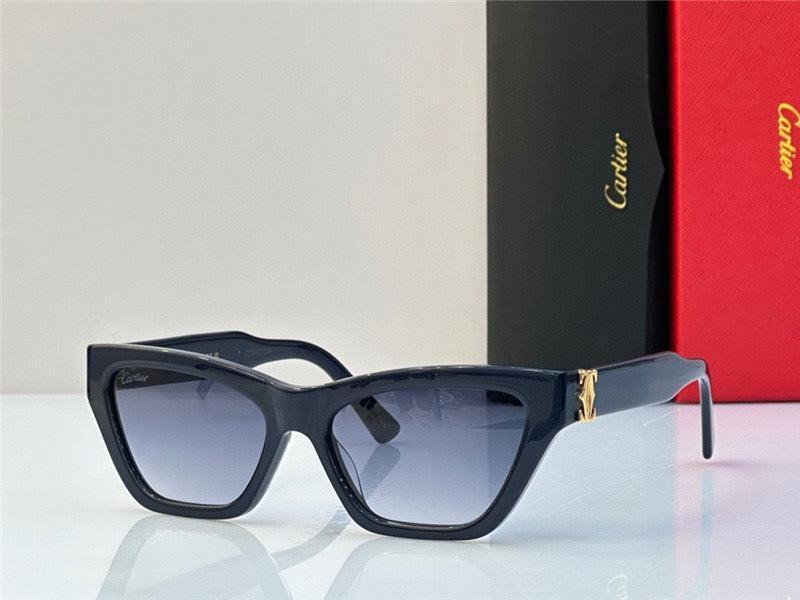 Black cat eye sunglasses with gold accent and gradient lenses on a white surface