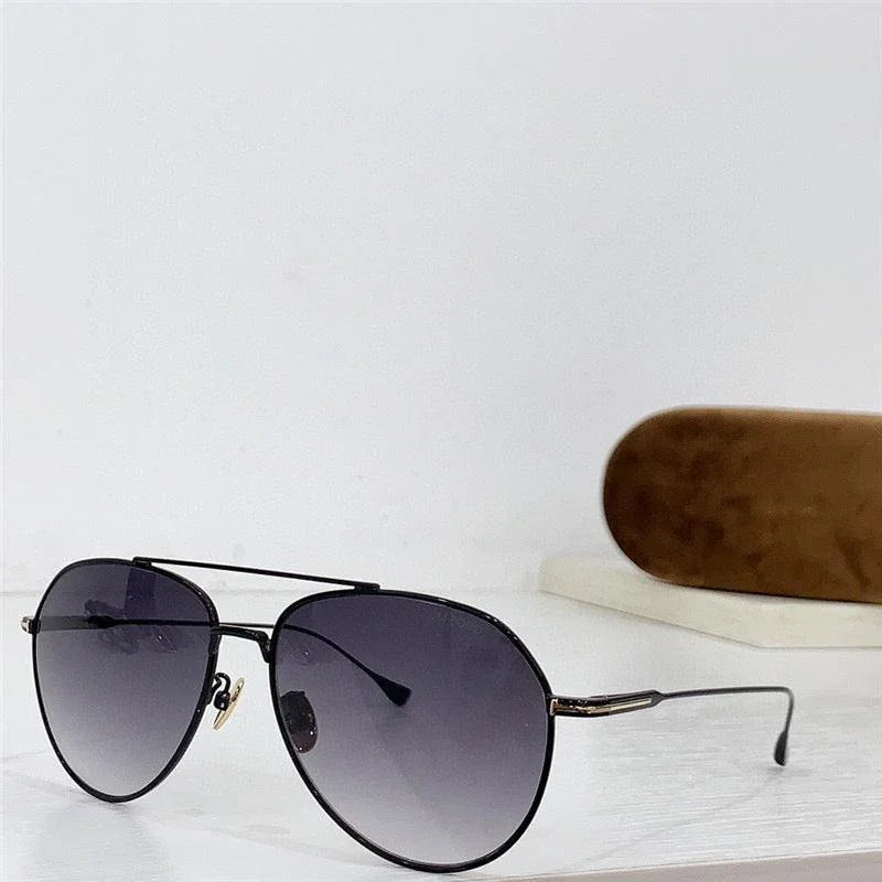 Aviator sunglasses with black gradient lenses and thin metal frame, displayed on white surface
