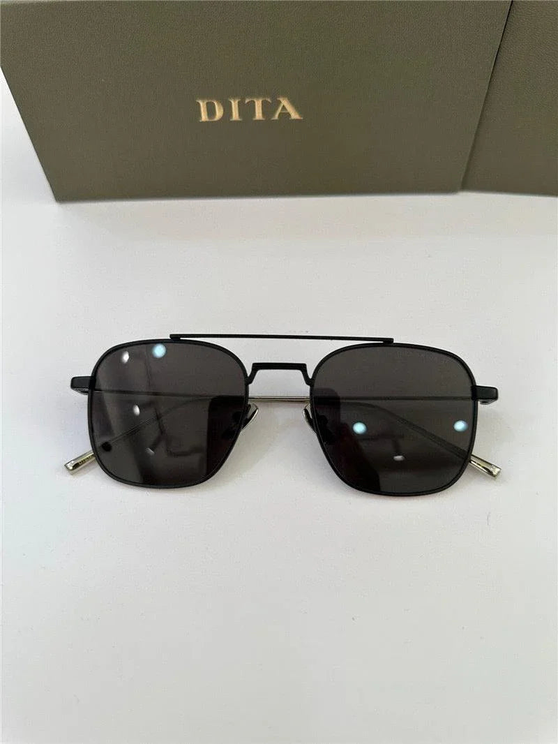 Black square aviator sunglasses with dark lenses on white background, DITA box behind