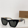 Black square oversized sunglasses with patterned arms and dark lenses on white surface