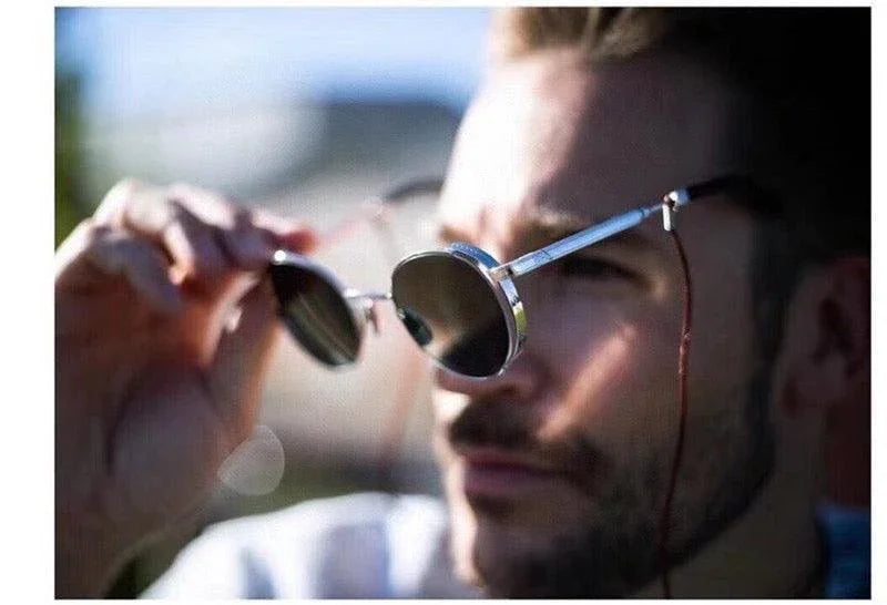 Man wearing round polarized sunglasses with metal frames in sunlight