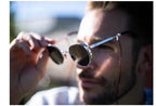 Man wearing round polarized sunglasses with metal frames in sunlight