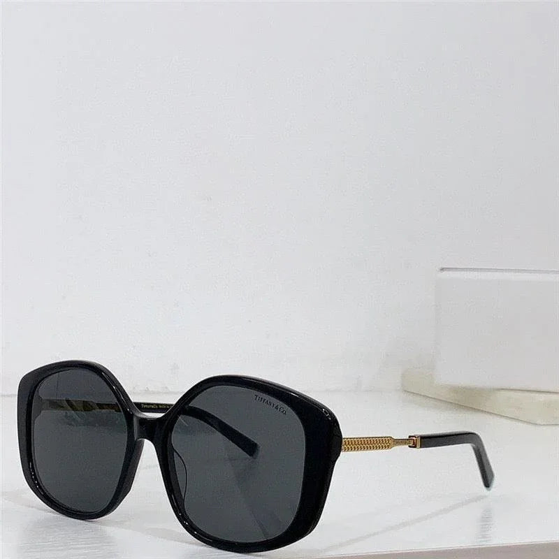 Black oversized sunglasses with gold arms, UV400 polarized lenses on white background