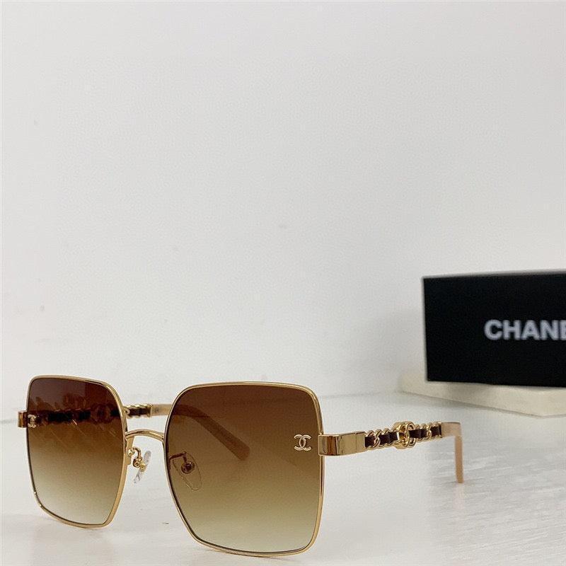 Square gold sunglasses with brown gradient lenses and chain detail on temples