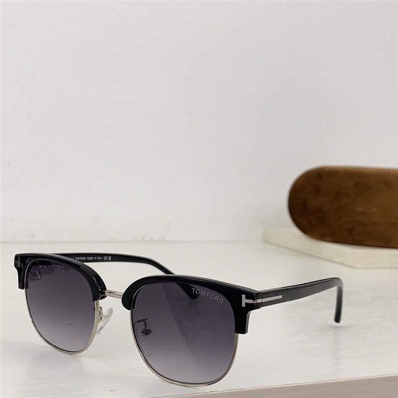 Black Tom Ford sunglasses with gradient lenses and classic browline frame on a white surface.