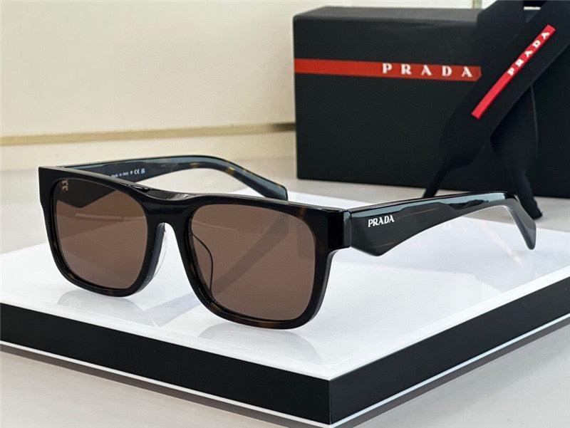 Prada rectangular black sunglasses with dark lenses on display, luxury eyewear packaging