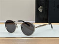 Round black sunglasses with silver metal frame on display, luxury eyewear accessories.
