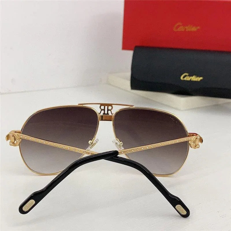 Gold aviator sunglasses with gradient lenses and luxury detailing on a white surface.