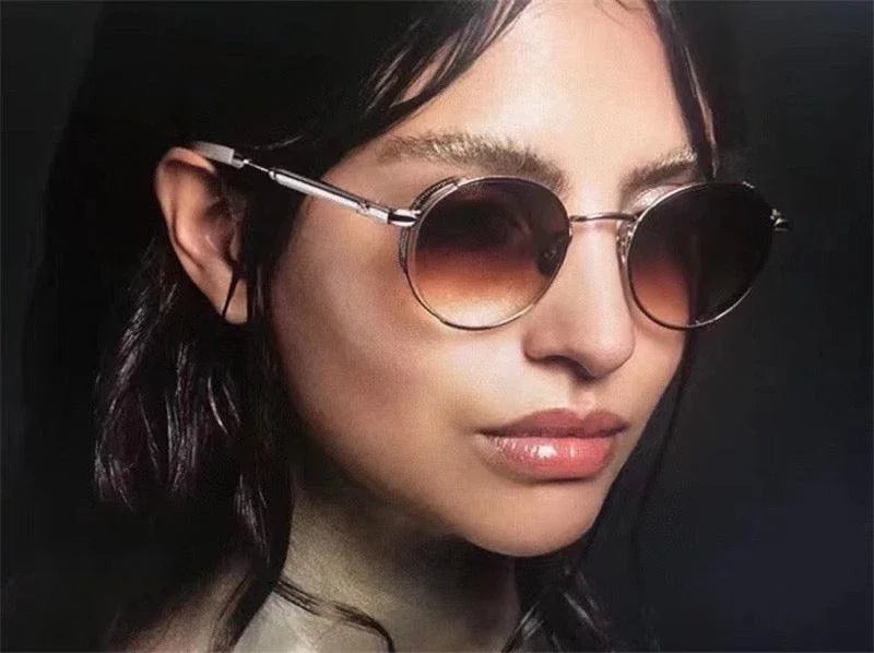 Woman wearing round gradient sunglasses with metal frames, fashion eyewear closeup