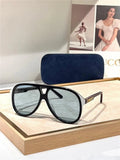 Black aviator sunglasses with blue-tinted polarized lenses and gold accents on display.