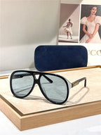 Black aviator sunglasses with blue-tinted polarized lenses and gold accents on display.